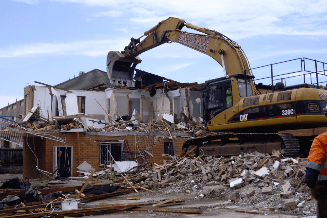 Photo of the 546–554 Milton Road, Toowong demolition project featuring a backhoe demolishing a home | Featured image for Coles, Rochedale.