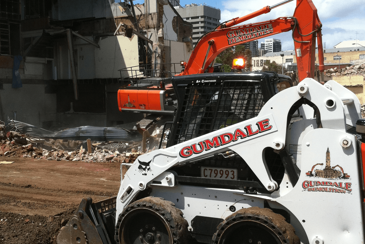 Photo of the Alderley Ruthven Streets Toowoomba demolition project featuring two machines operating on site | Featured image for Coles, Rochedale.