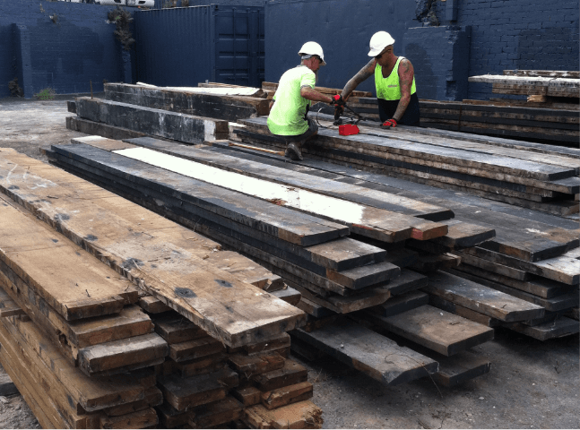 Men working on wood boards | Featured image for Commercial Demolition Brisbane page Gumdale Demolitions