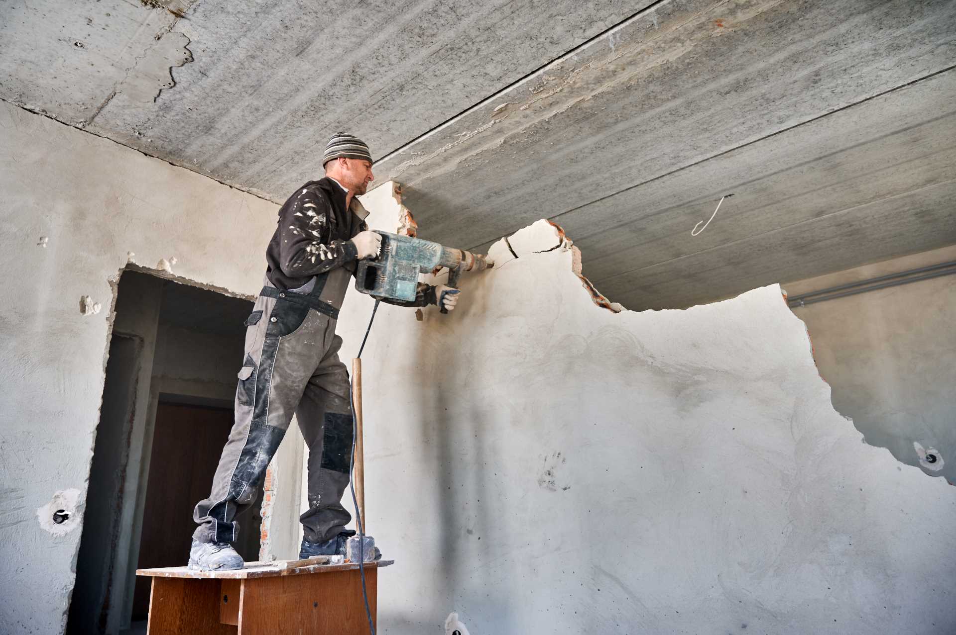Builder demolishing an internal wall | Featured image for the What Is Partial Demolition and When Is It Needed? blog by Gumdale Demolition.