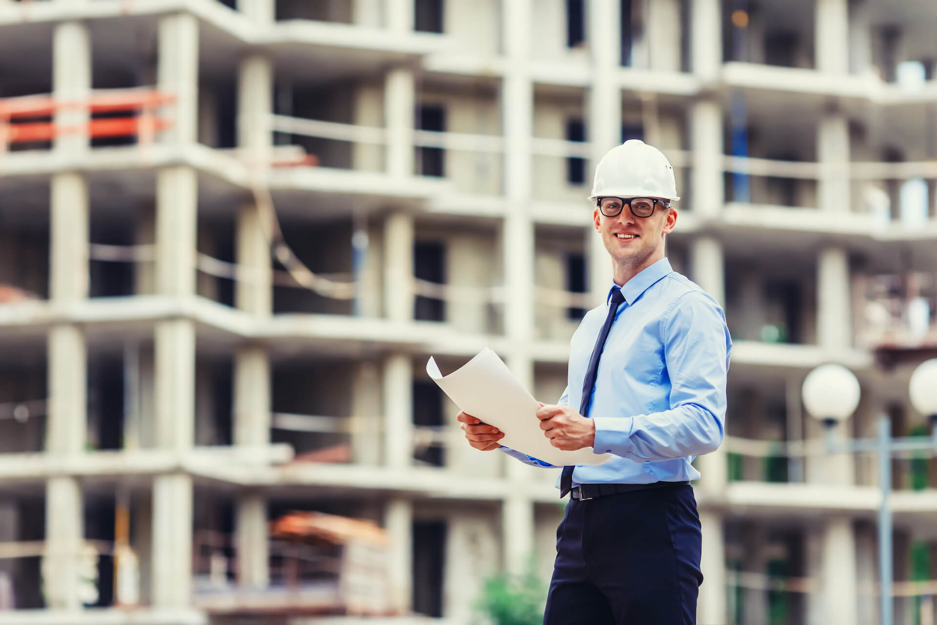 Smiling construction engineer on site | Featured image for the Warehouse Demolition Landing Page for Gumdale Demolition.